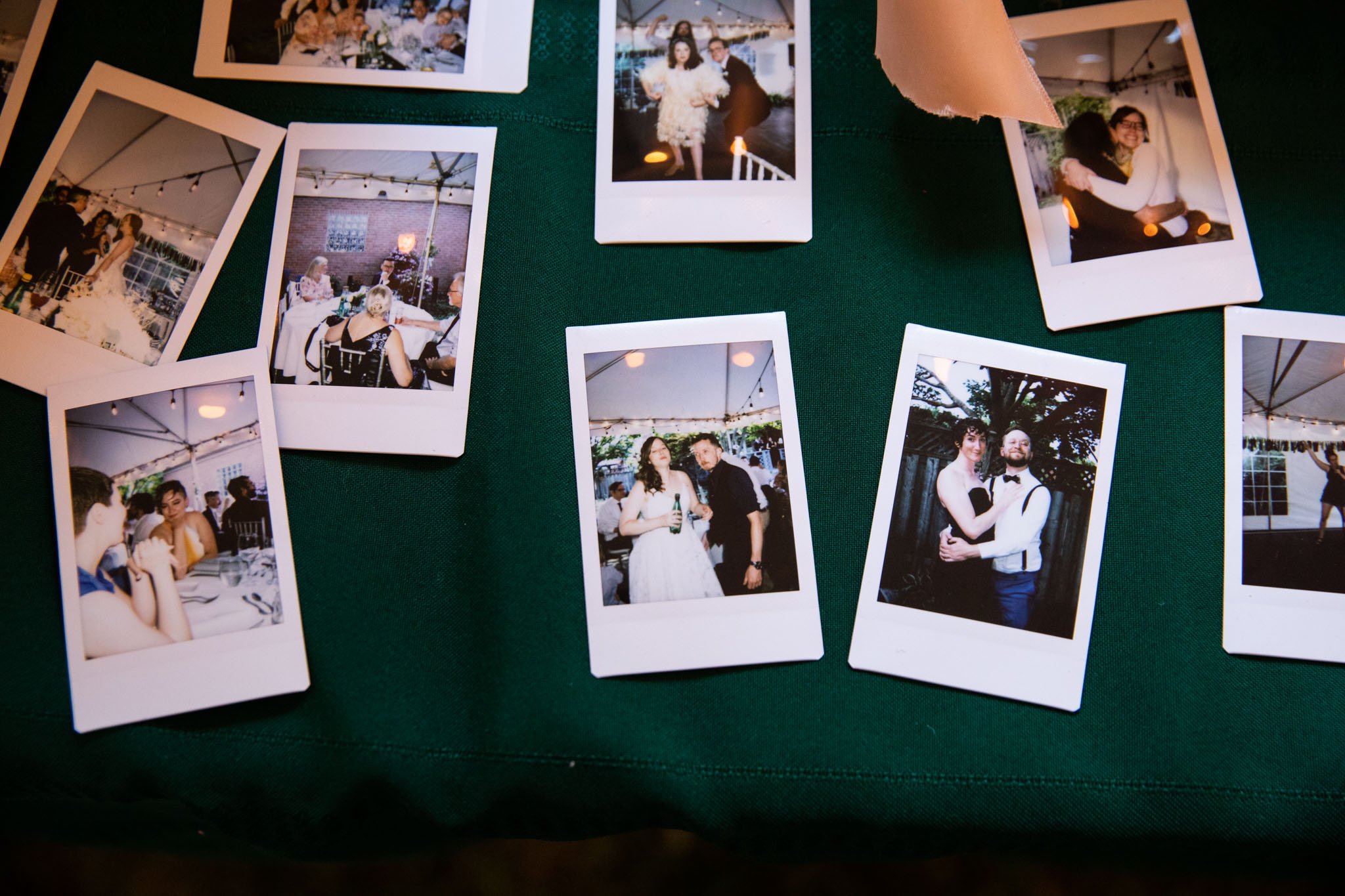 instax taken by wedding guests on a table - top down view.jpg