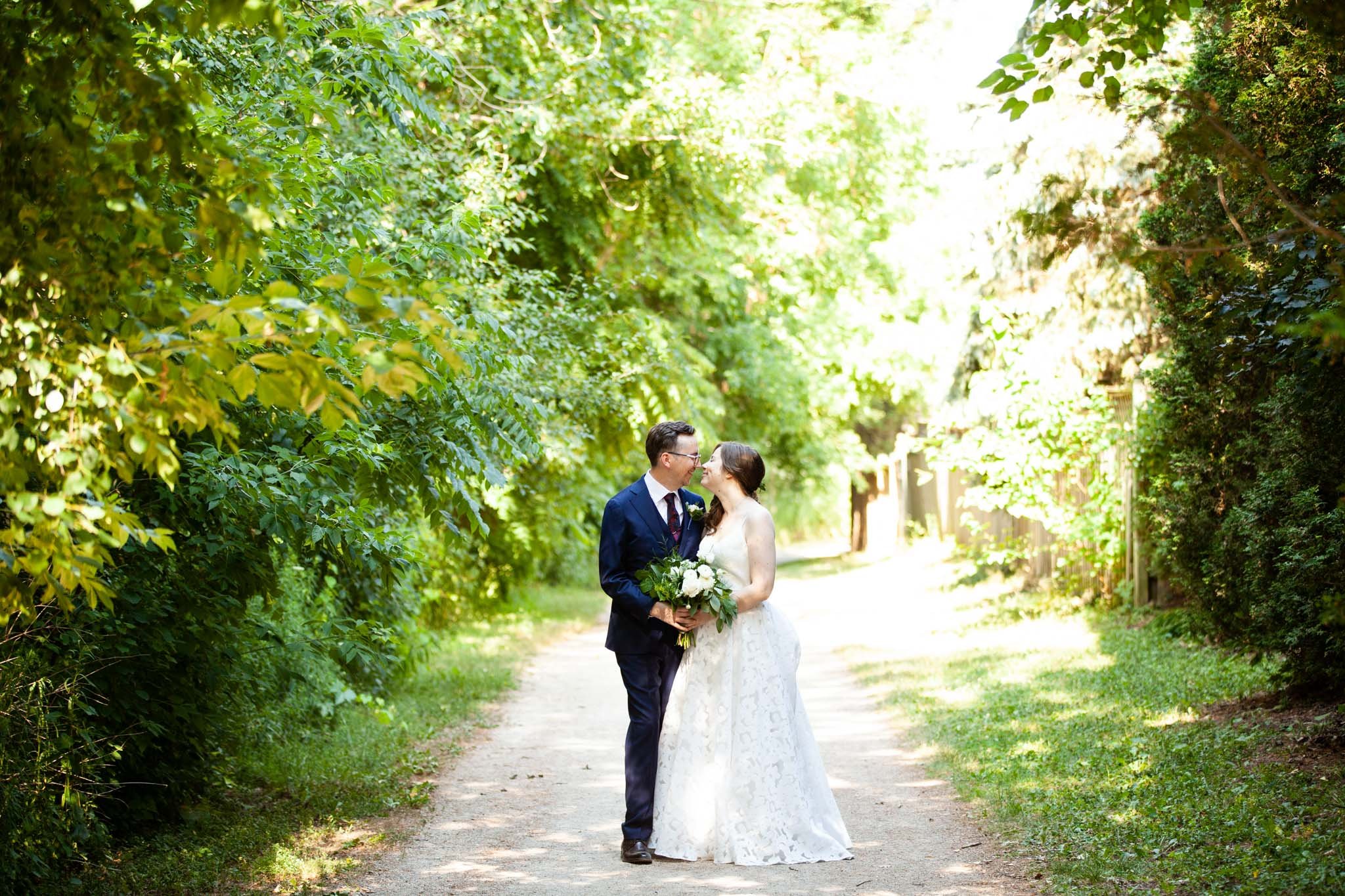 landscape shot of wedding couple on a path in a park.jpg