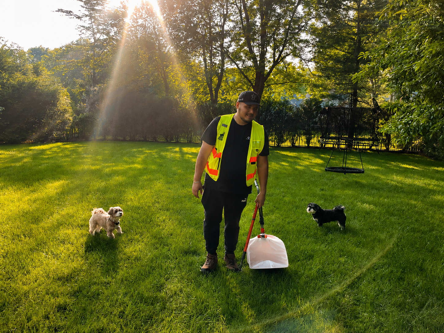 Big Business Scoopers technician providing pet waste removal service in a residential backyard