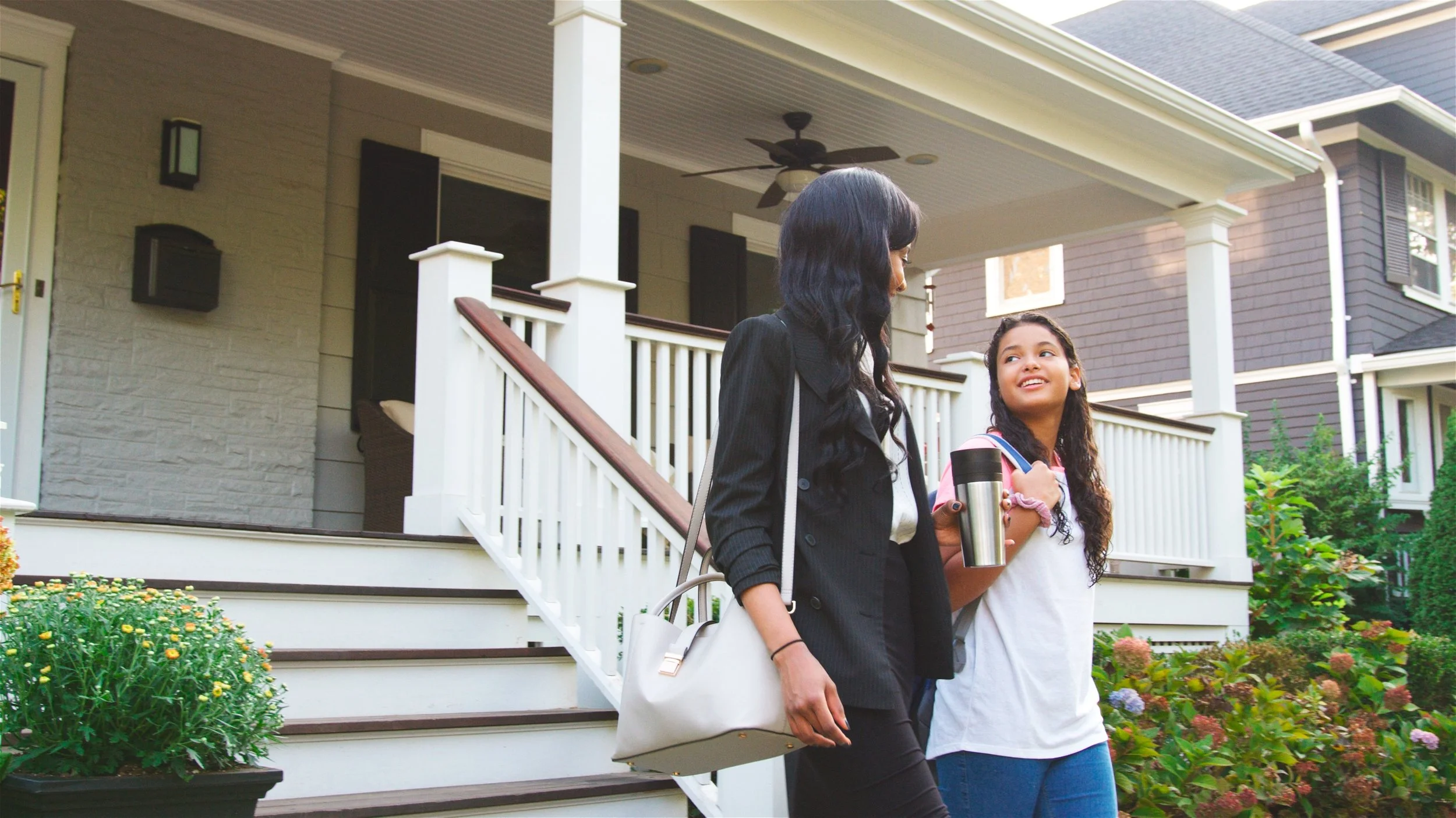 Woman leaving home with her daughter, illustrating that homeowners do not need to be home for pet waste removal service.