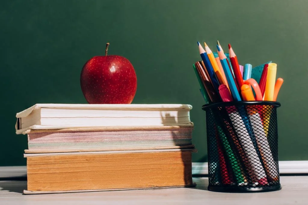 stock-photo-ripe-apple-books-pen-holder.jfif