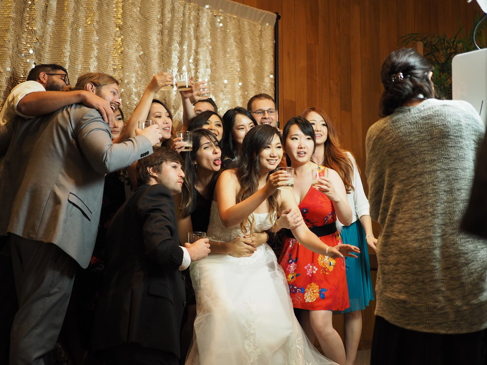 Bride and her wedding partyenjoying their honolulu photobooth rental