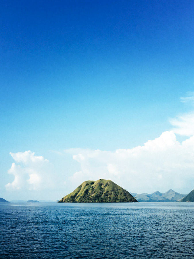One of Komodo National Park’s 29 islands. This beautiful reserve was established in 1980 and was declared a UNESCO World Heritage Site in 1991.&nbsp;The blue water, green hills, and ever changing clouds... We’ll never tire of this view. The Indonesi…