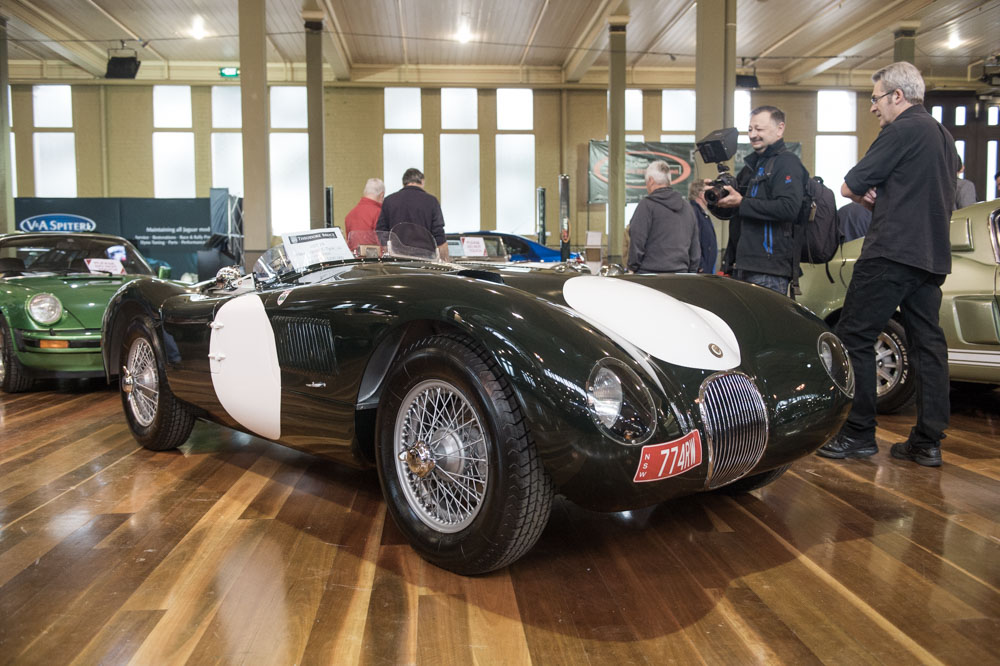 A 1964 Jaguar C-Type replica waiting in the auction area.