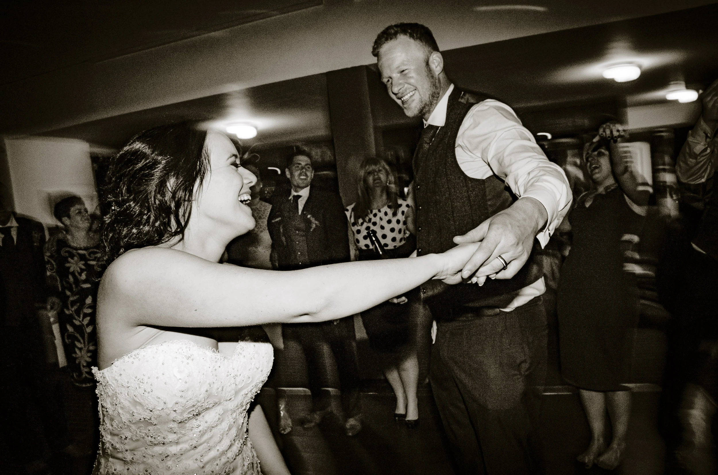 Bride and Groom dancing in the middle of the dancefloor. Mark twirling Kim.