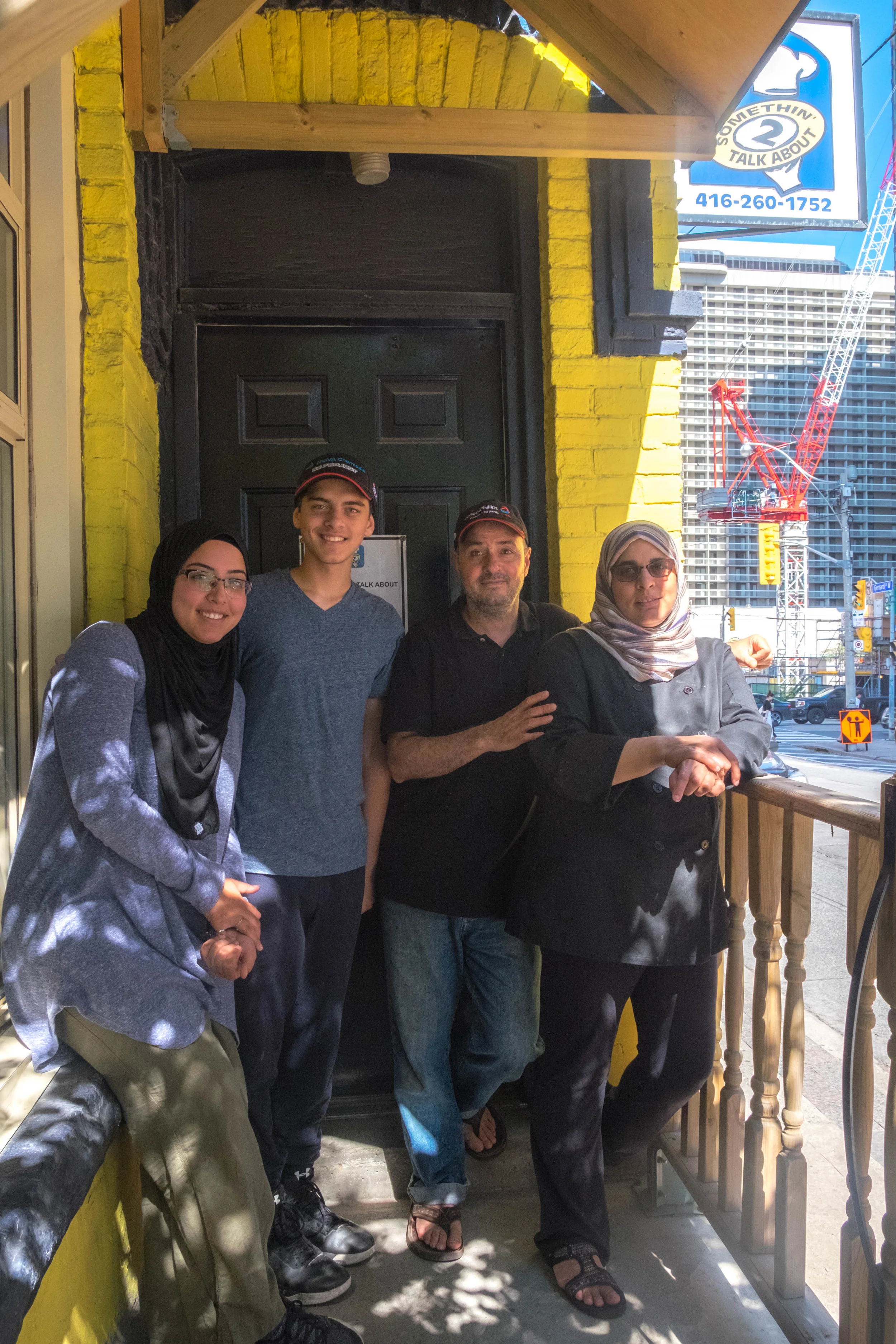 Adhela and her family and employees