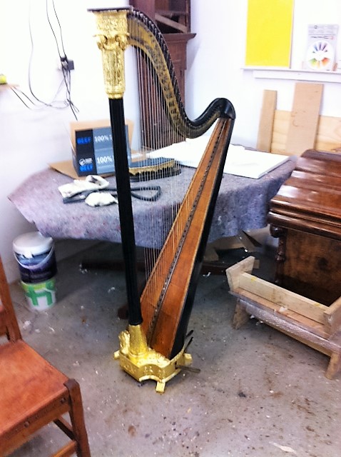 An antique harp, restored details, re-gilded and re-polished
