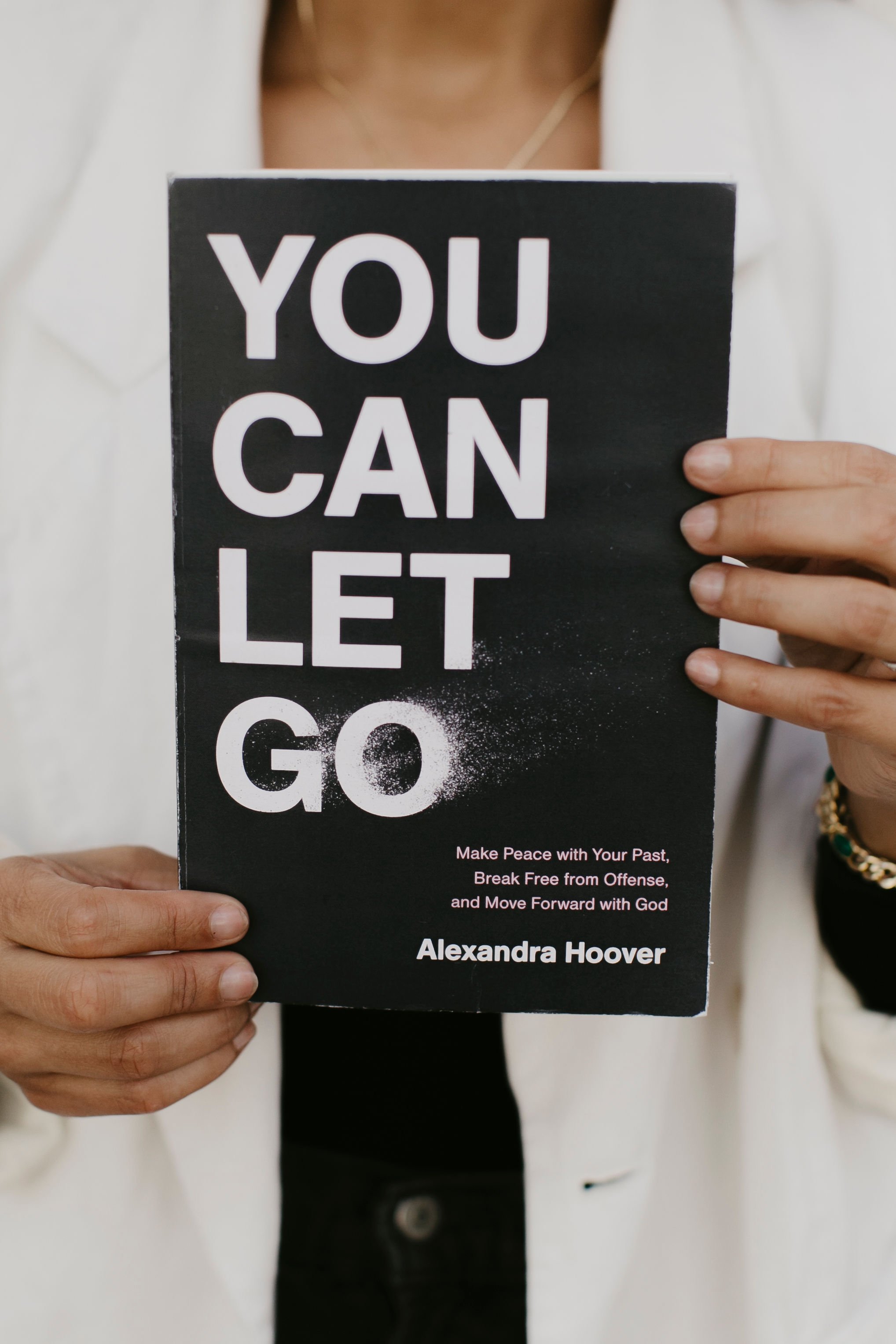 Close up of Christian author Alexandra Hoover holding her book You Can Let Go