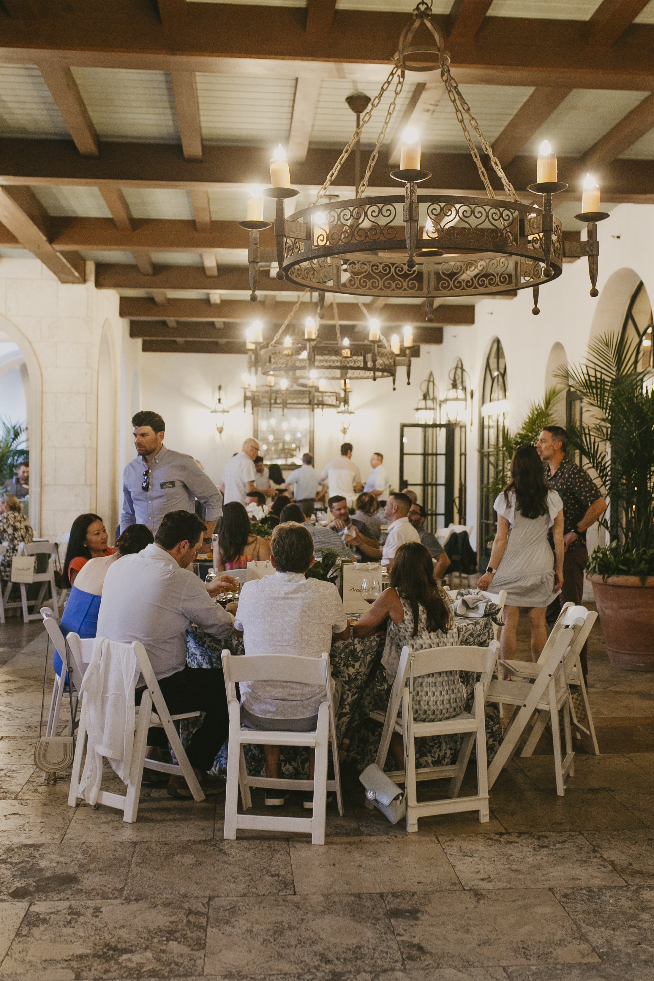 Conference dinner under iron chandeliers in the loggia at The Cloister at Sea Island