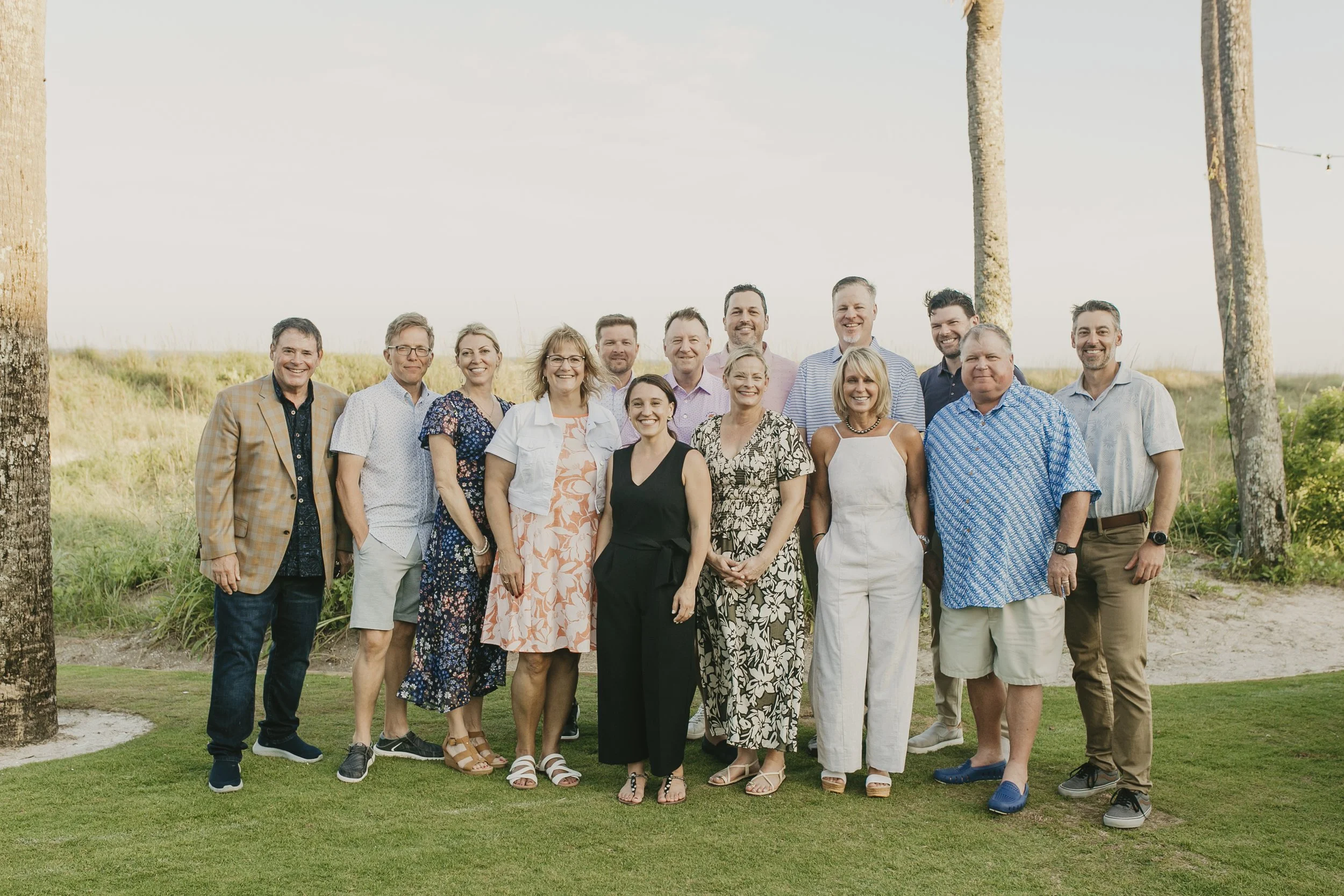 Corporate team group photo on the lawn by the dunes at Sea Island Resort