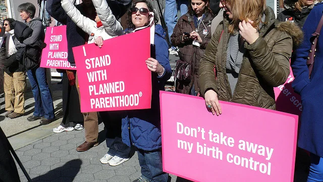 Placards from Planned Parenthood rally in New York City by Women’s eNews is licensed under CC BY 2.0 .