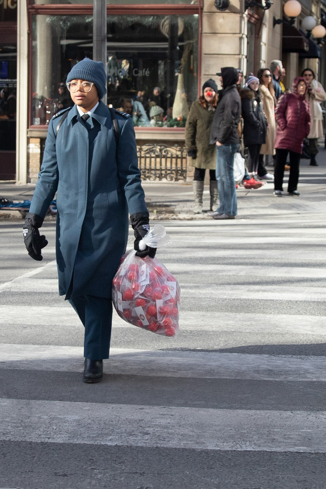  A Cadet carrying a bag of Rudolph red noses.  