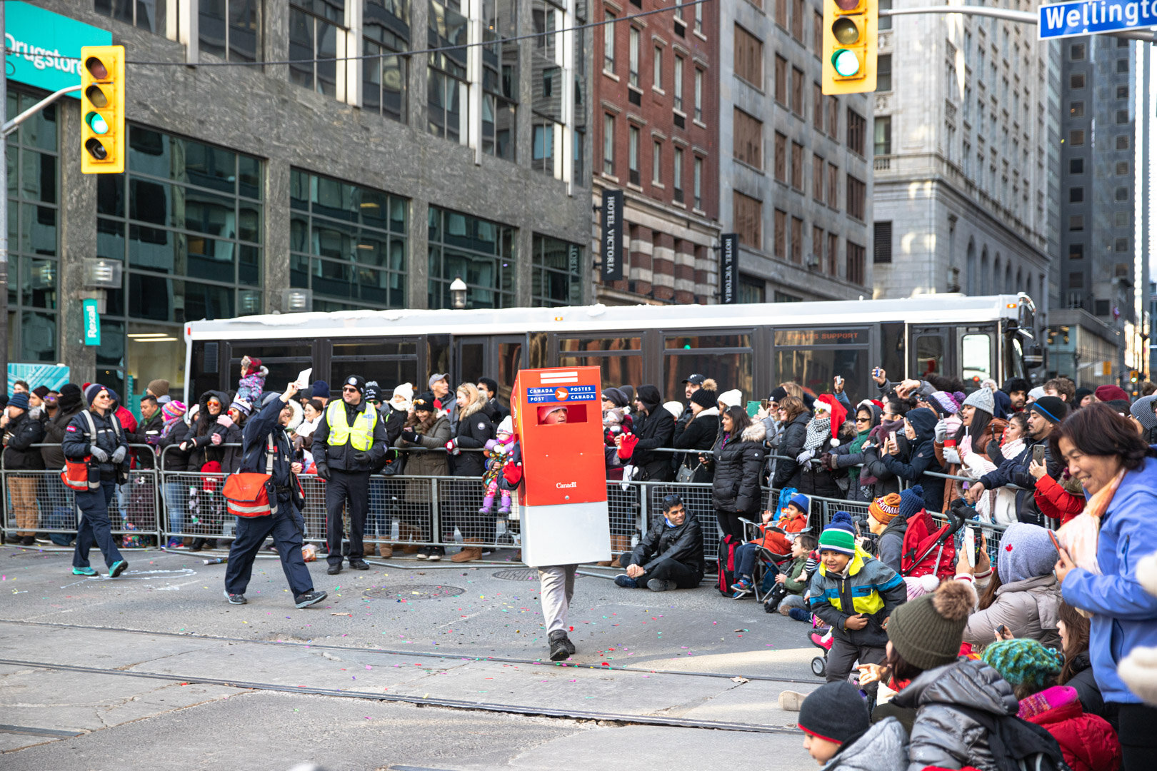  Canada Post workers say hello to the crowd. These workers also collect letters from children in the crowd to be delivered to Santa. 