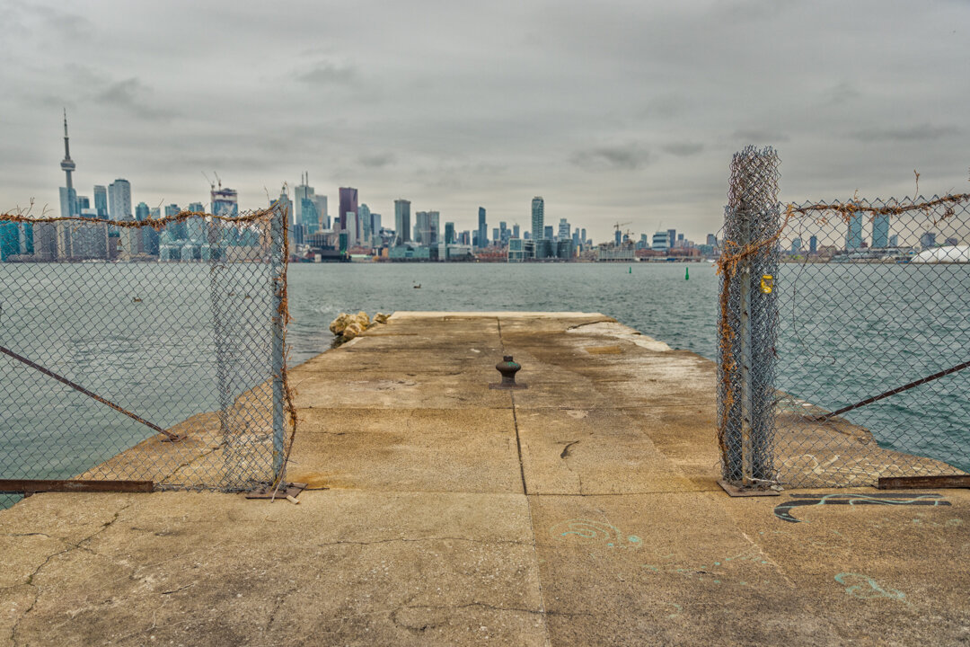  A view of the pier on Ward’s Island with the Toronto Skyline behind the fence. 