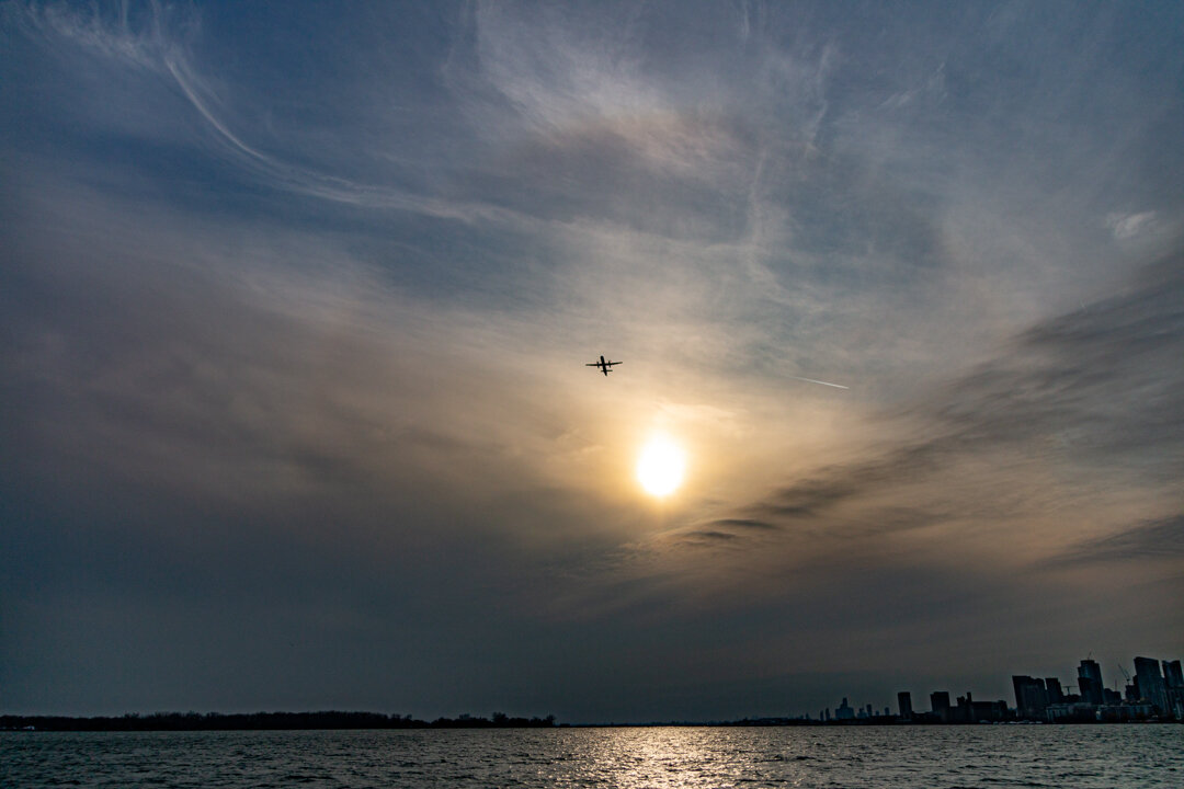  Looking out from the port side of the Ongiara is a view of a Bombardier Q400 turbo prop aircraft run by Porter Airlines.     