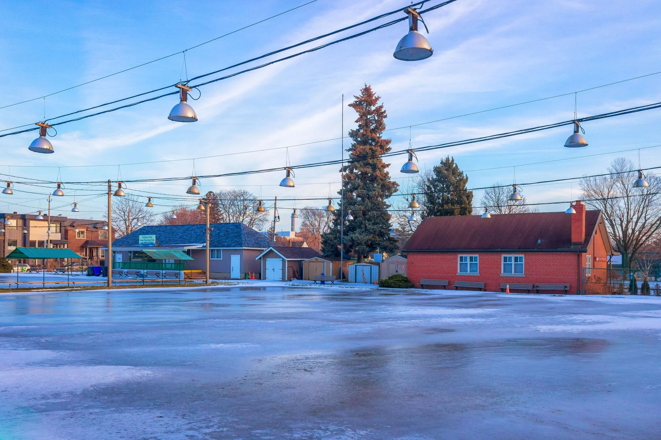 Overhead lights span the frozen courts at East York Tennis Club in East York, Toronto.
