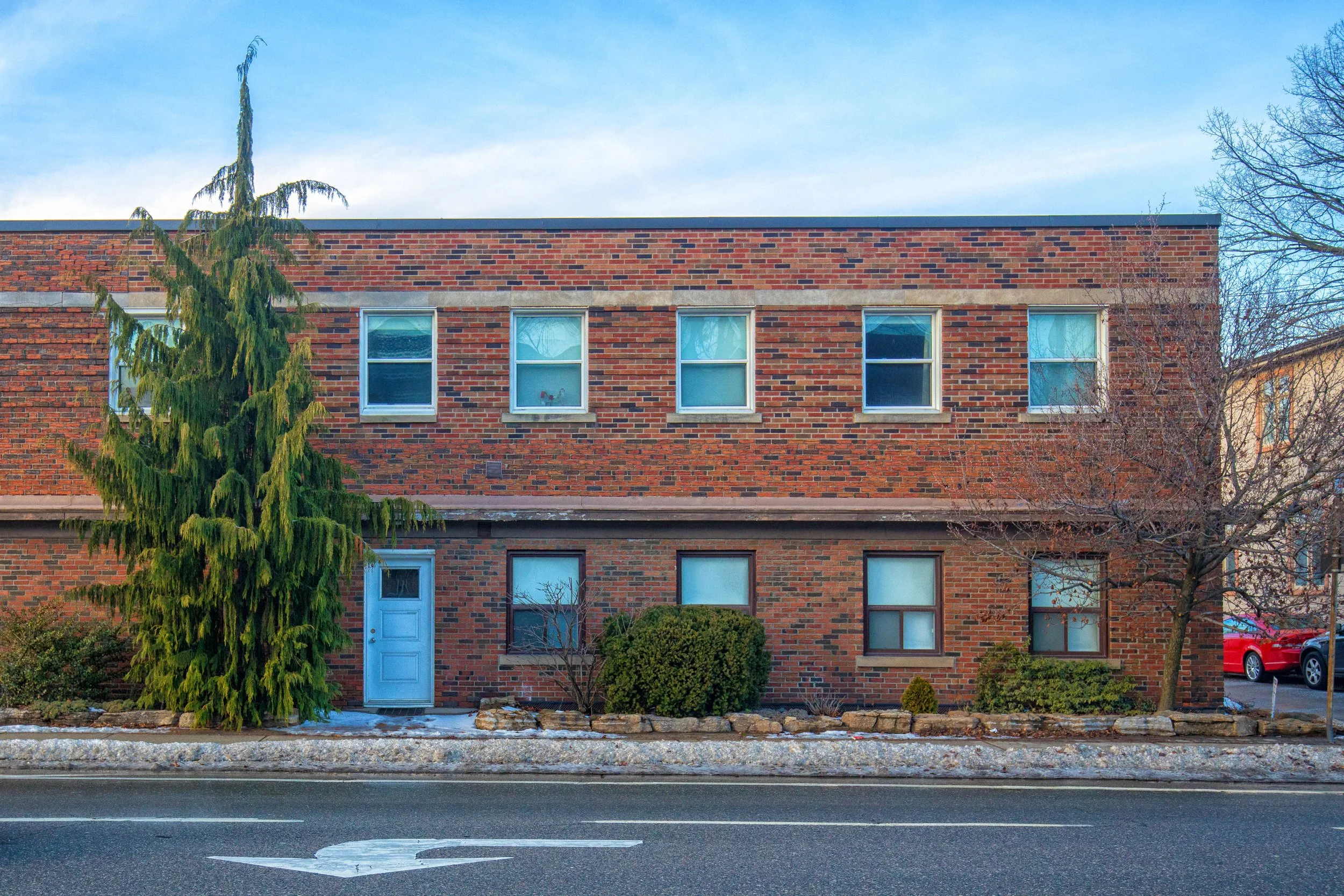 Low-rise brick apartment building along Cosburn Avenue in East York