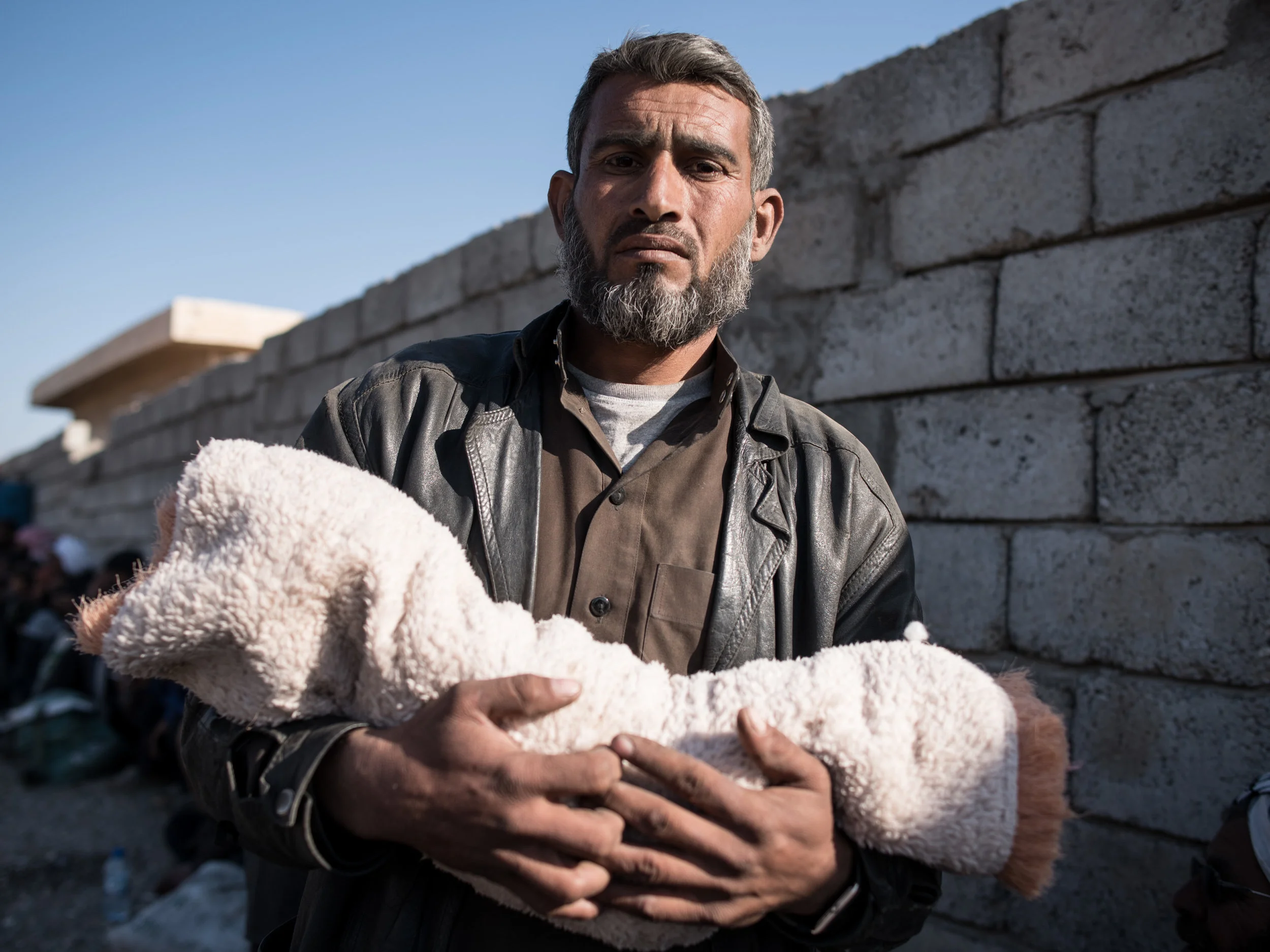 A DESERT BURIAL As civilians flee Iraqi offensive, grief-stricken family buries two-month-old girl under mud and rocks - Daily Telegraph