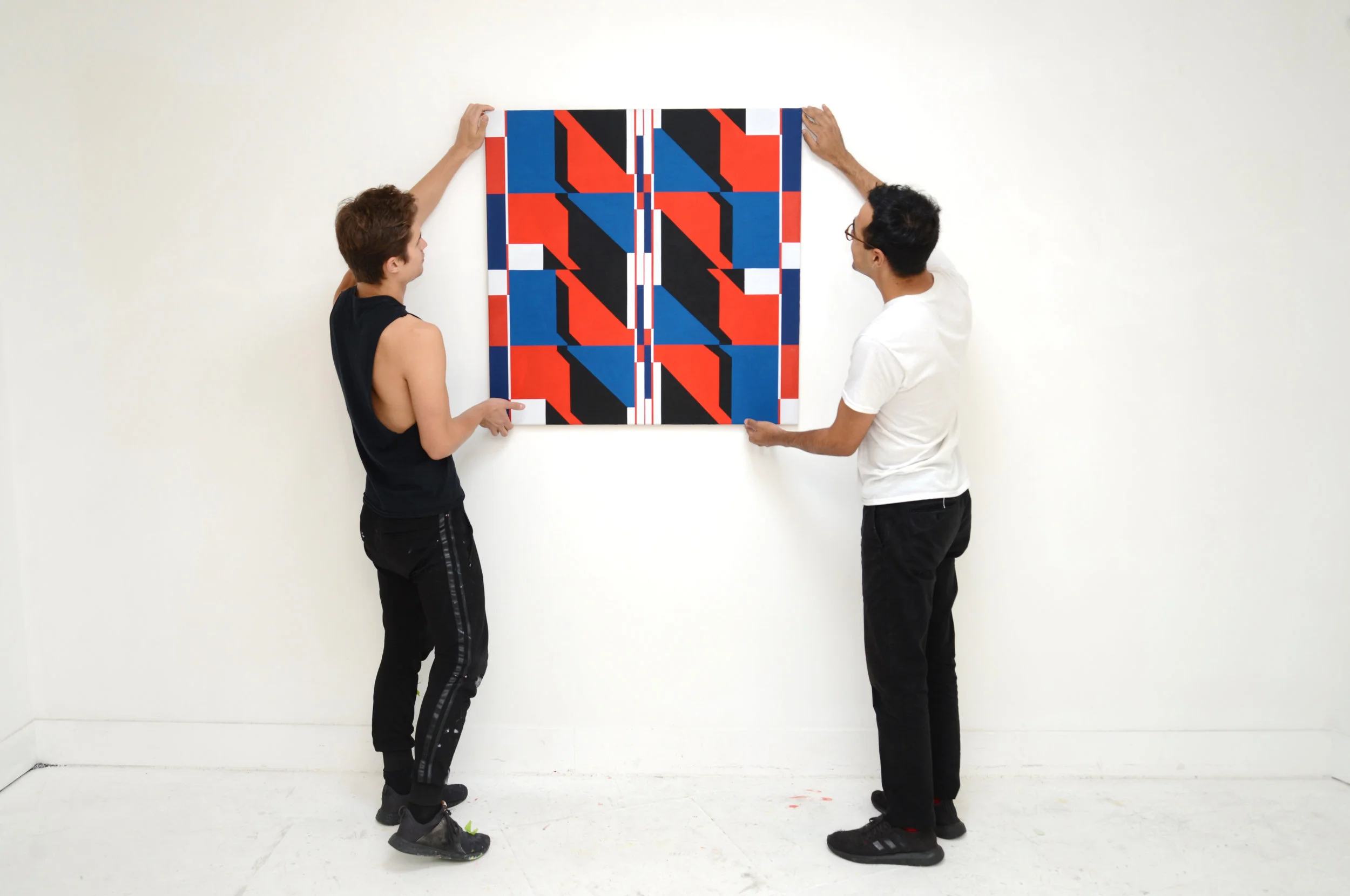 Kevin Umaña and Brandon Lipchik hanging the end of residency show in August 2018. (Artwork: Kevin Umaña)