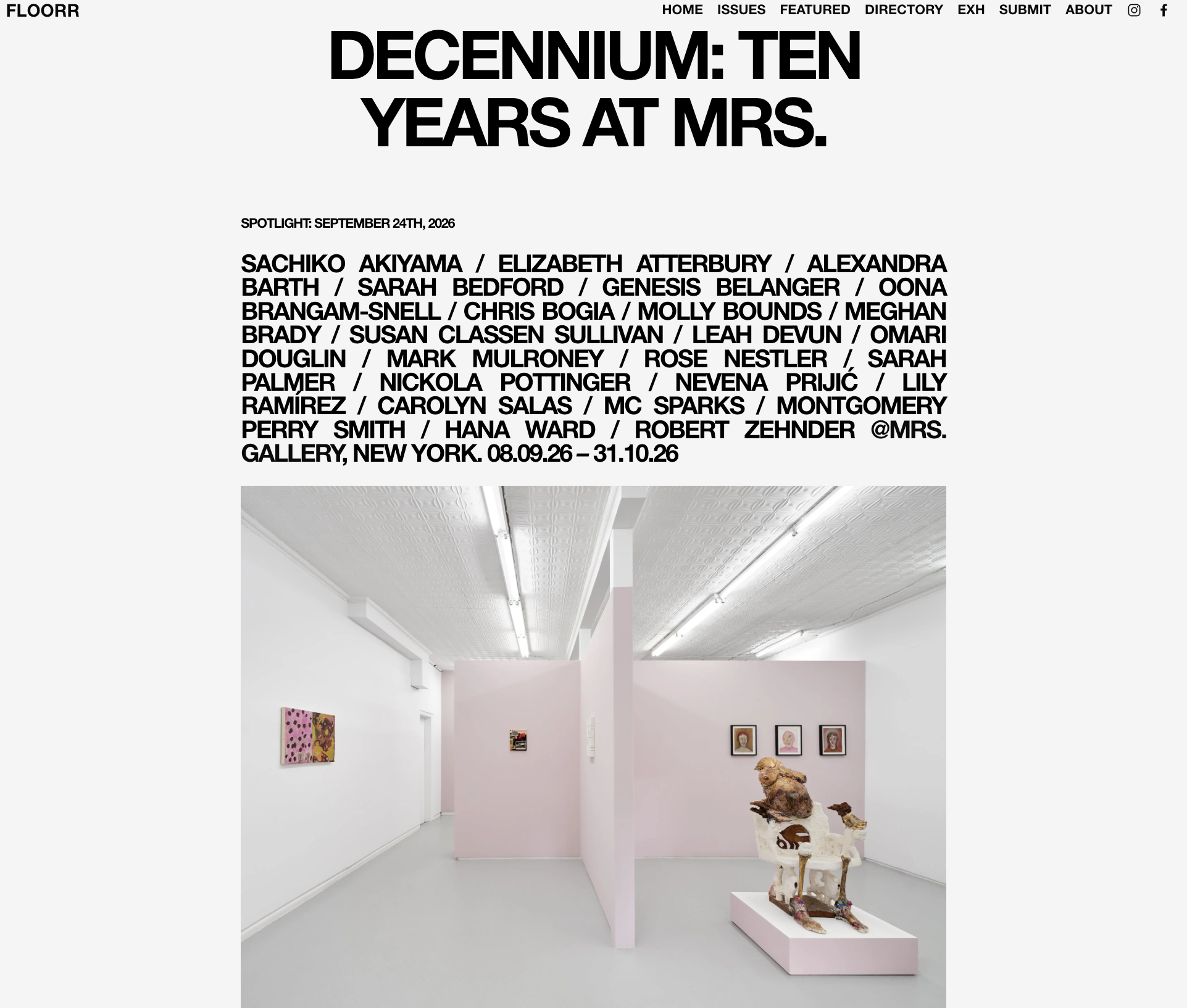 Interior view of an art gallery with white walls and a pink partition. Artwork including colorful paintings and sculptures on pedestals are displayed.