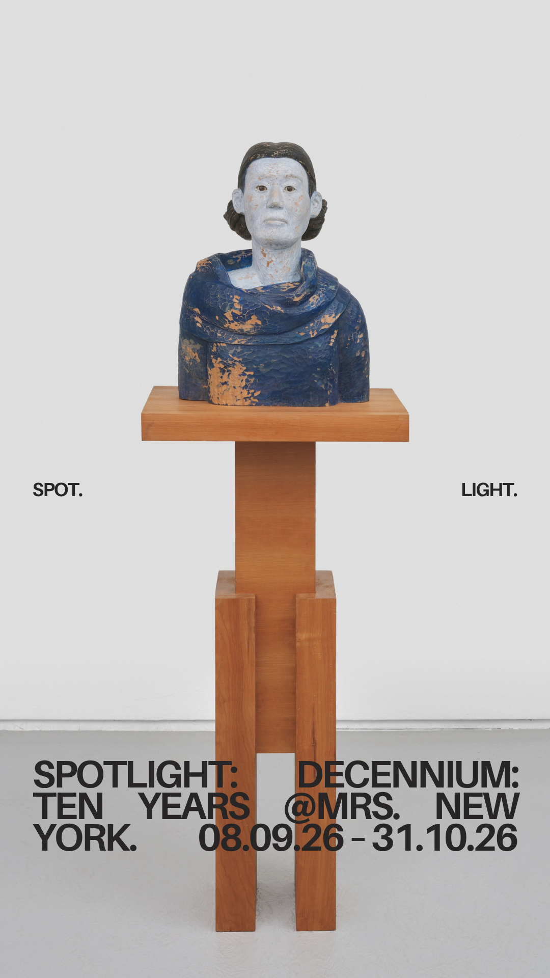 A sculpture of a woman with short hair wearing a blue scarf, displayed on a wooden stand against a white background. Text on the image indicates an art exhibition titled "Spotlight: Ten Years in New York" at Decennium, from August 26 to October 31, 2026.