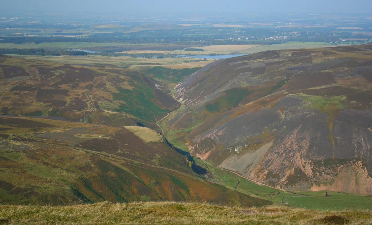 In autumn, looking north from Scald Law, Pentland Hills, to the Bavelaw path in the valley below. City of Edinburgh to the right.