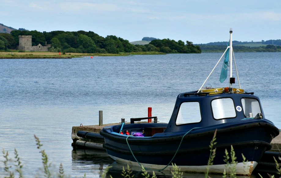 LochLeven castle in the distance - with the ferry boat to take you across.