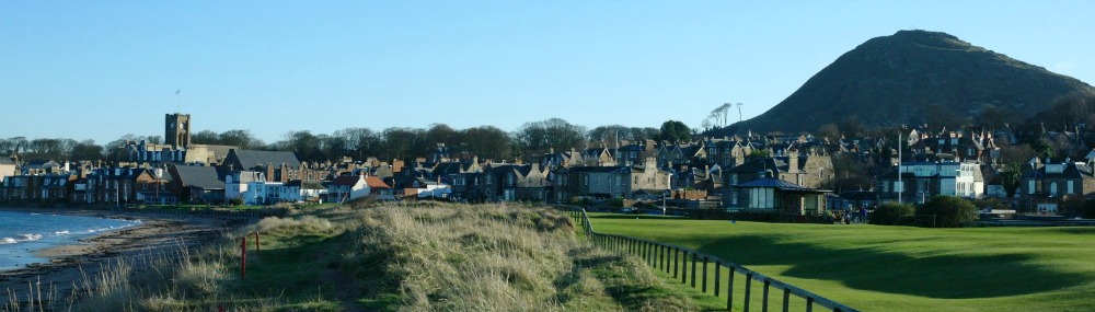 North Berwick - it has a beach, golf course, hill (law) and nice wee shops and cafes plus a direct rail link to Edinburgh.