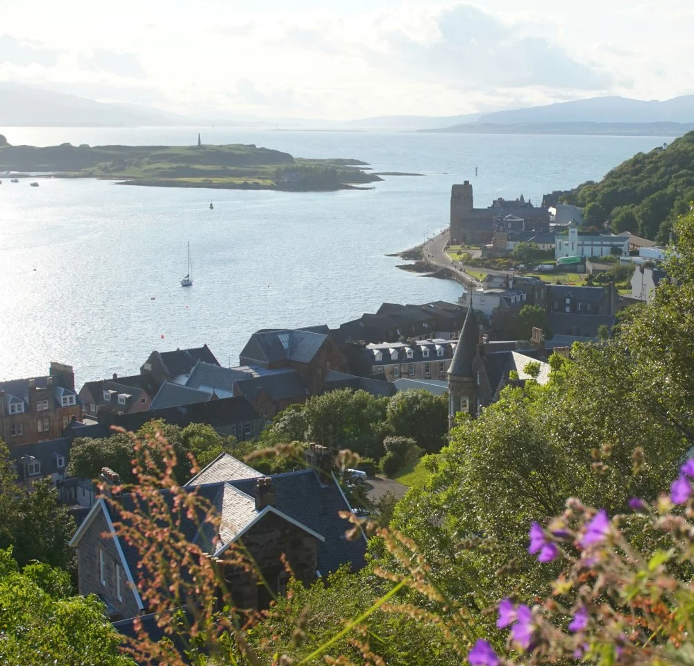 From McCaig's Tower. North end of town, with road to Ganavan Sands running round by the church tower, upper right. Tip of island of Kerrera upper left.