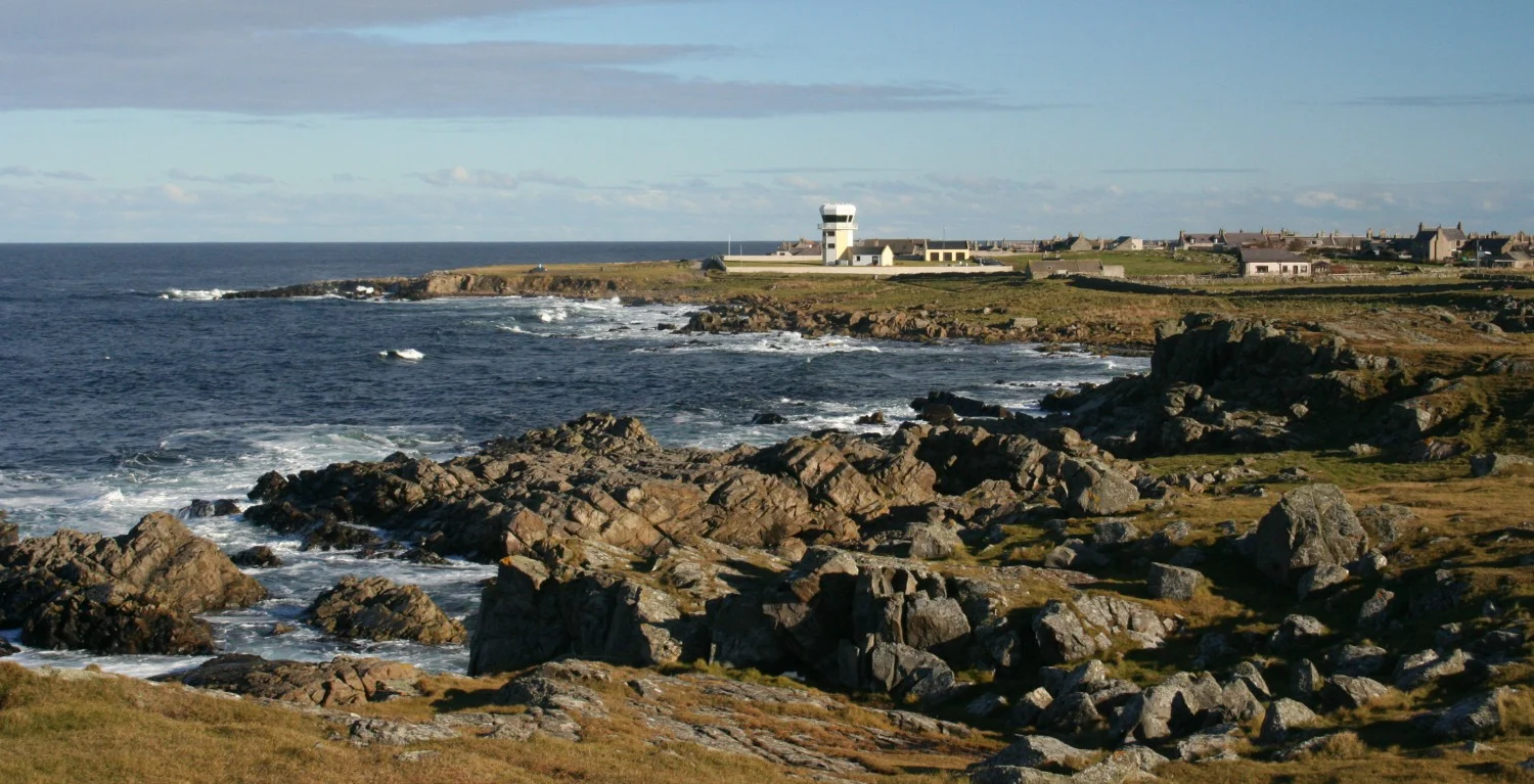 Looking east to the village of Rosehearty. The odd-looking tower-like building was an observation tower built shortly before the bombing range here was closed. It is now a private house.