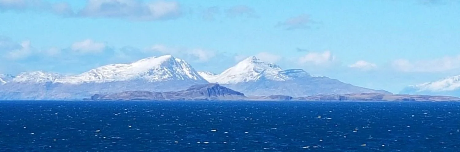 Hills of Rum prominent and very white, island of Muck in front. View from the lighthouse. Credit: Funcya-Flycup Marketing.