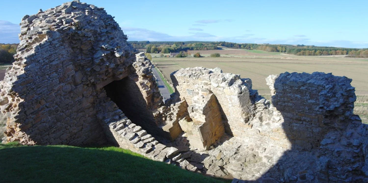 Goodbye, north wall. Here at Duffus Castle the stonework has parted company from the main structure. Still, it’s about 700 years old! Note today’s approach road, just left of centre.