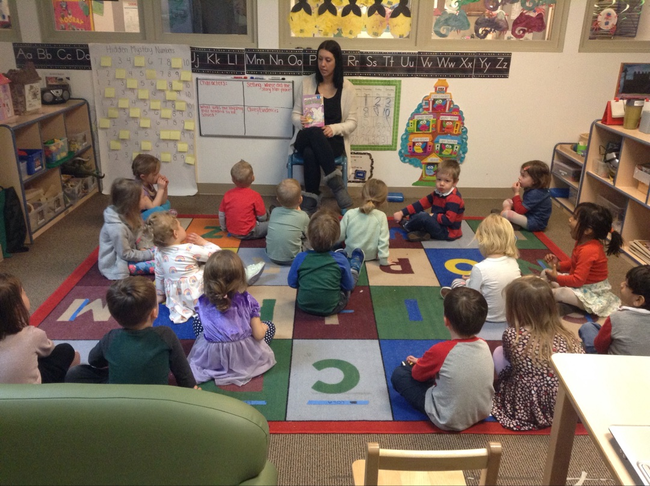 Preschool students gather for circle time and begin their day with a story.