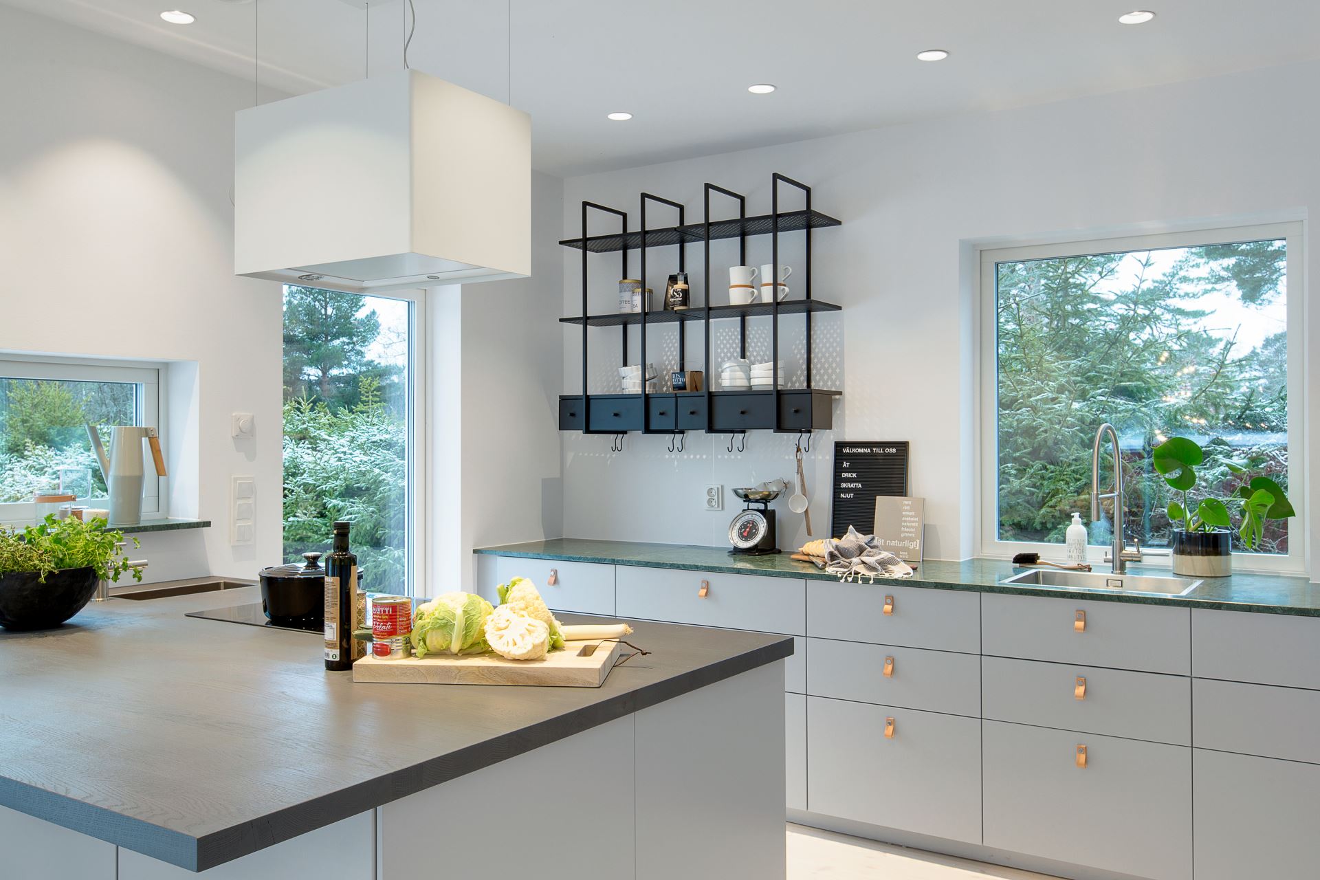 Modern Scandinavian kitchen with green marble countertops.