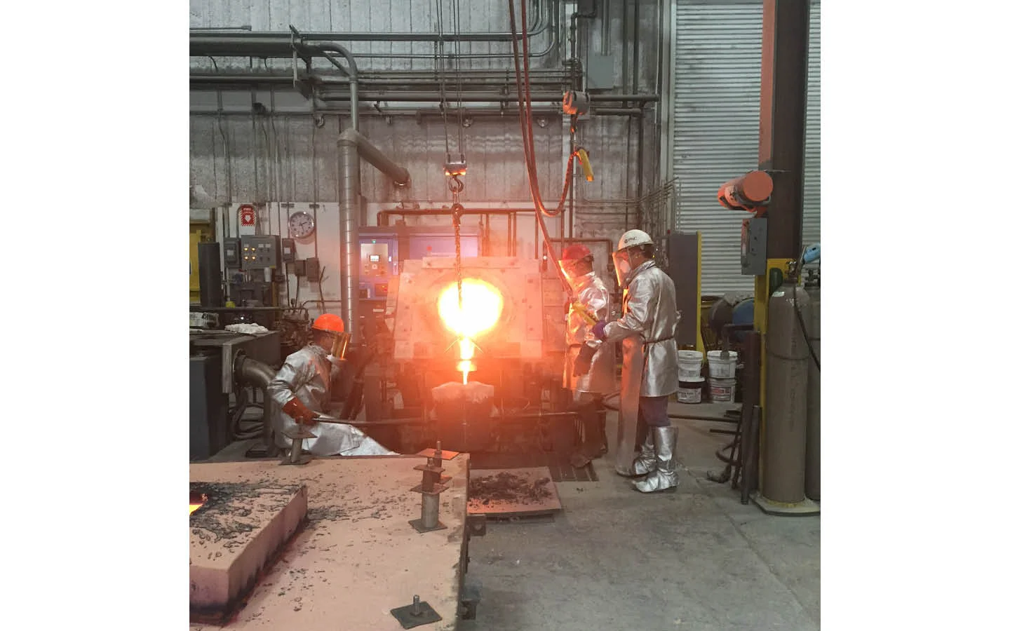 Then the molten bronze is transferred from the furnace to a poring vessel