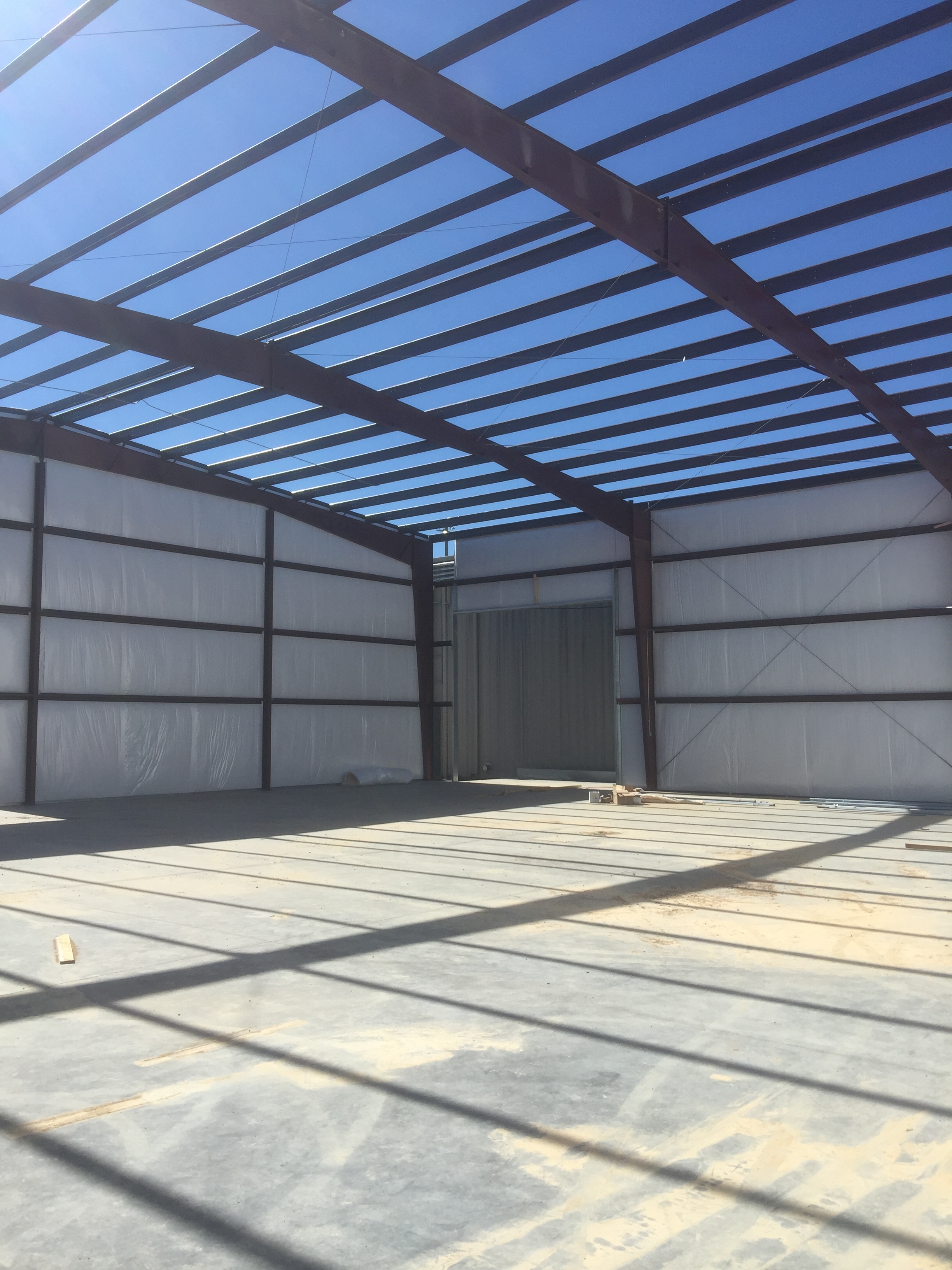 These linear shadows will disappear as soon as the roof goes up and light fixtures are installed with new T5 highbay lighting. This will be a great new space for Coosa Composites. This building will feature highly efficient fluorescent high bay fixtures that will reduce energy consumption and maintenance substantially.