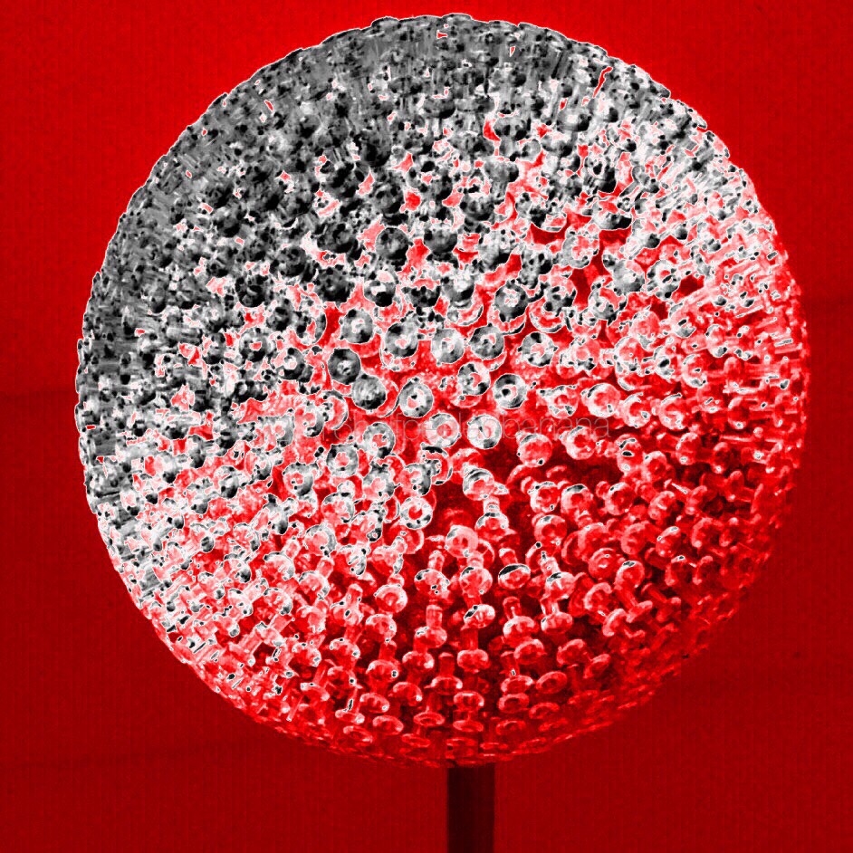 black silver and red photo of a 7" flower made of push pins