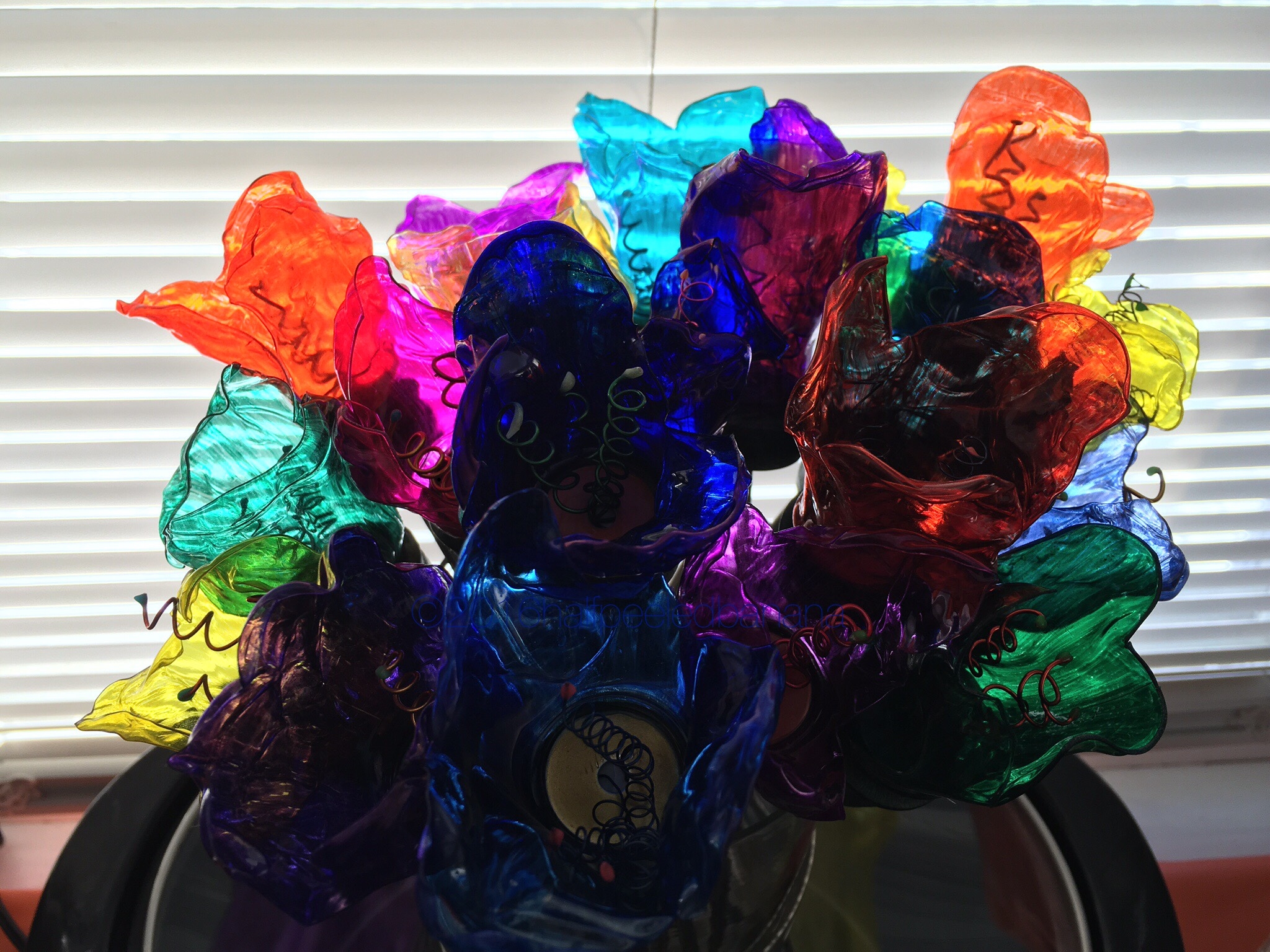 perfect in the light! this bouquet was artfully created from upcycled water bottles!