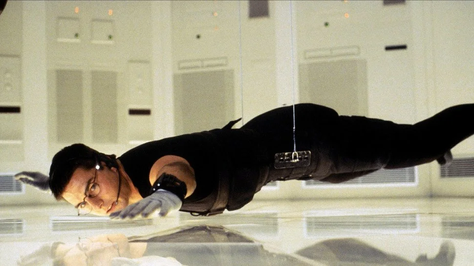 A white guy in form-fitting black clothes hovering inches above the floor.