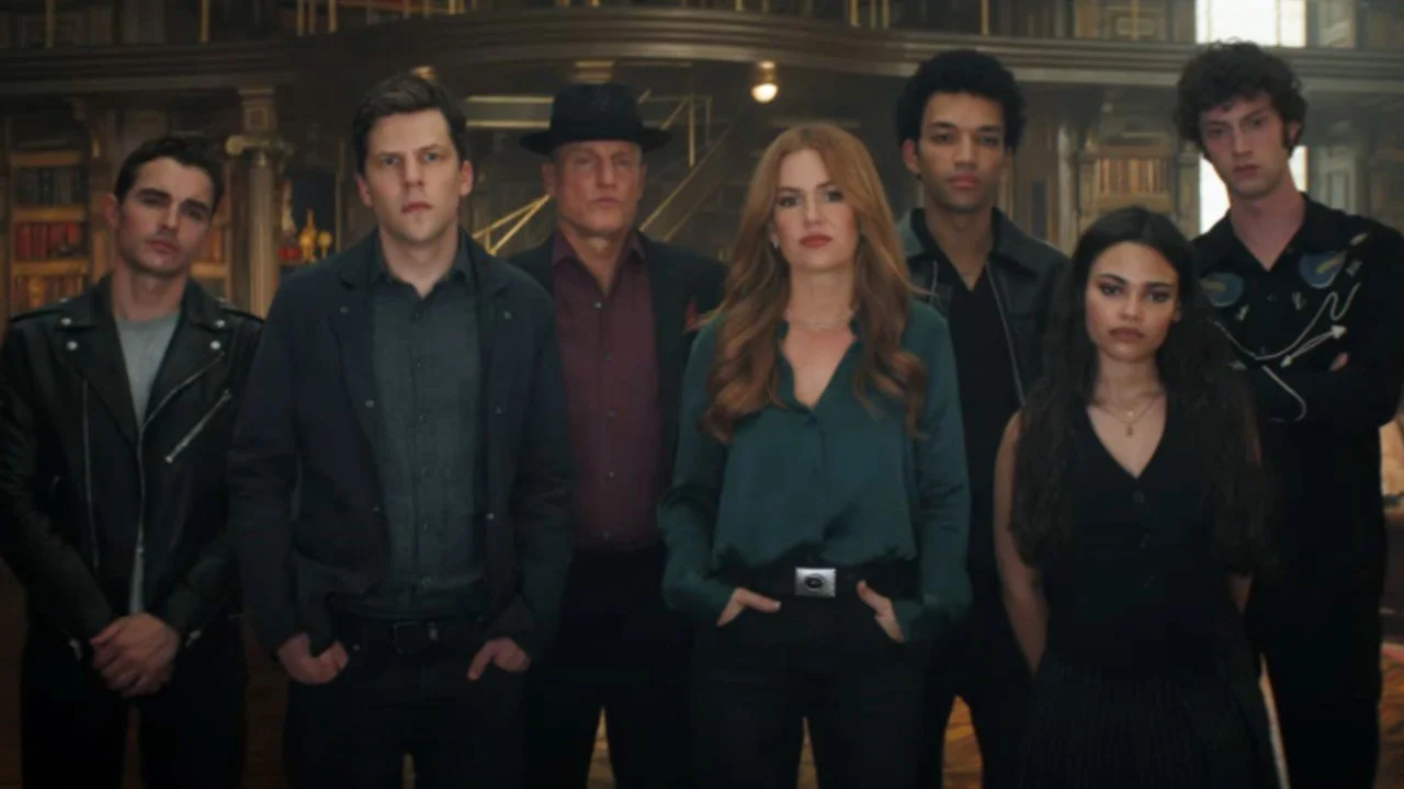 Seven people lined up in front of a library backdrop.