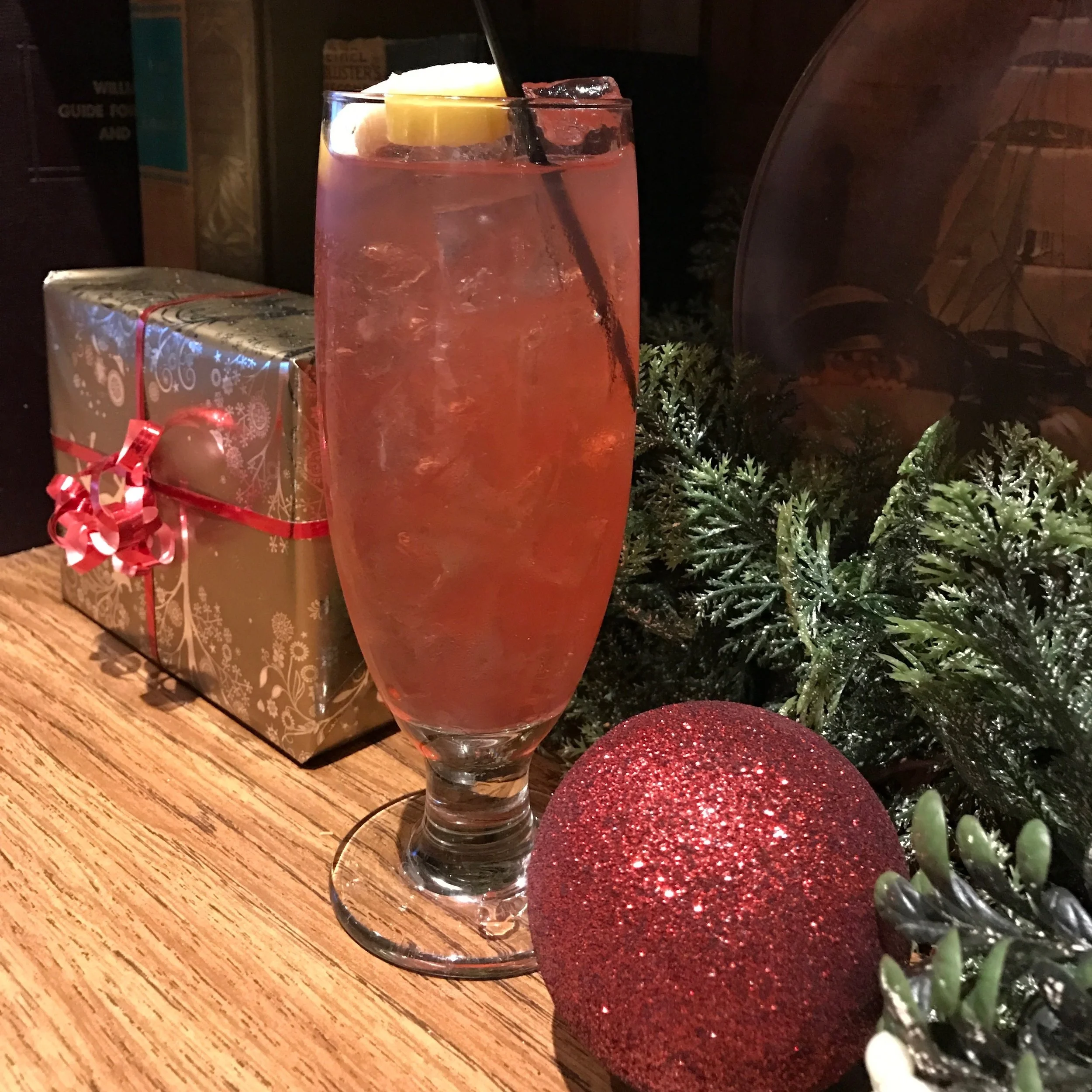 BOURBON PUNCH Five & 20 Bourbon, lemonade, pomegranate, served in a cocktail glass and garnished with a lemon twist. 