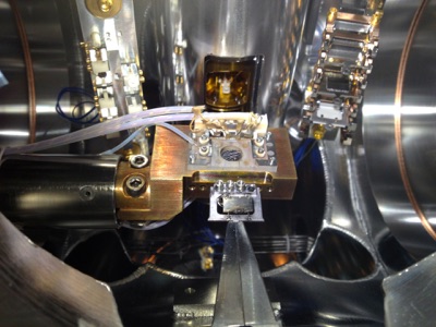 Sample transfer from STM chamber to manipulator. Ag(111) crystal is mounted on a specially designed sample holder with type-K thermocouple contacts. The STM chamber wobblestick is inserting the sample into the manipulator for preparation.