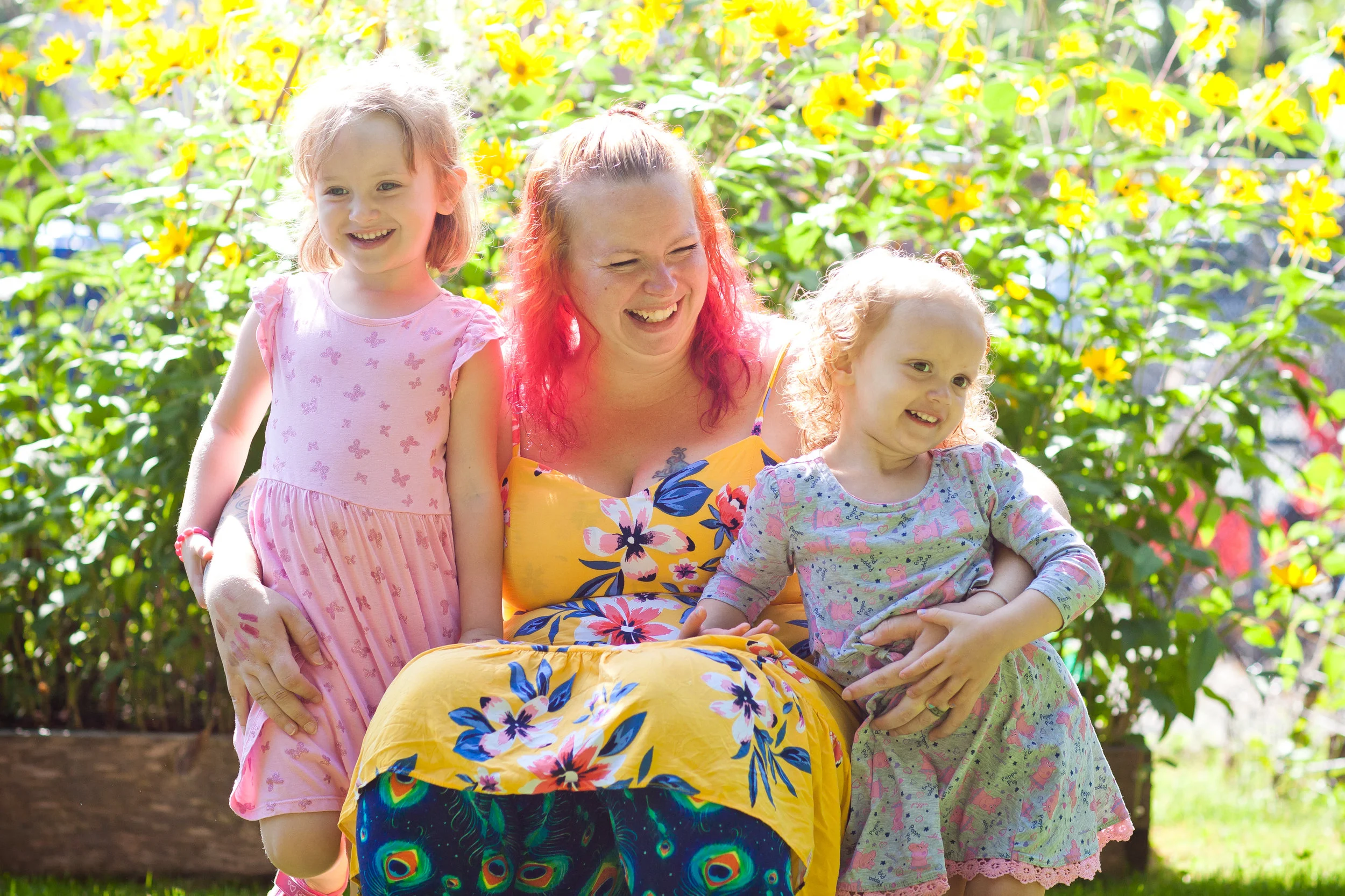 April laughs with her two daughters. Photo courtesy of Snickerdoodle Photography.