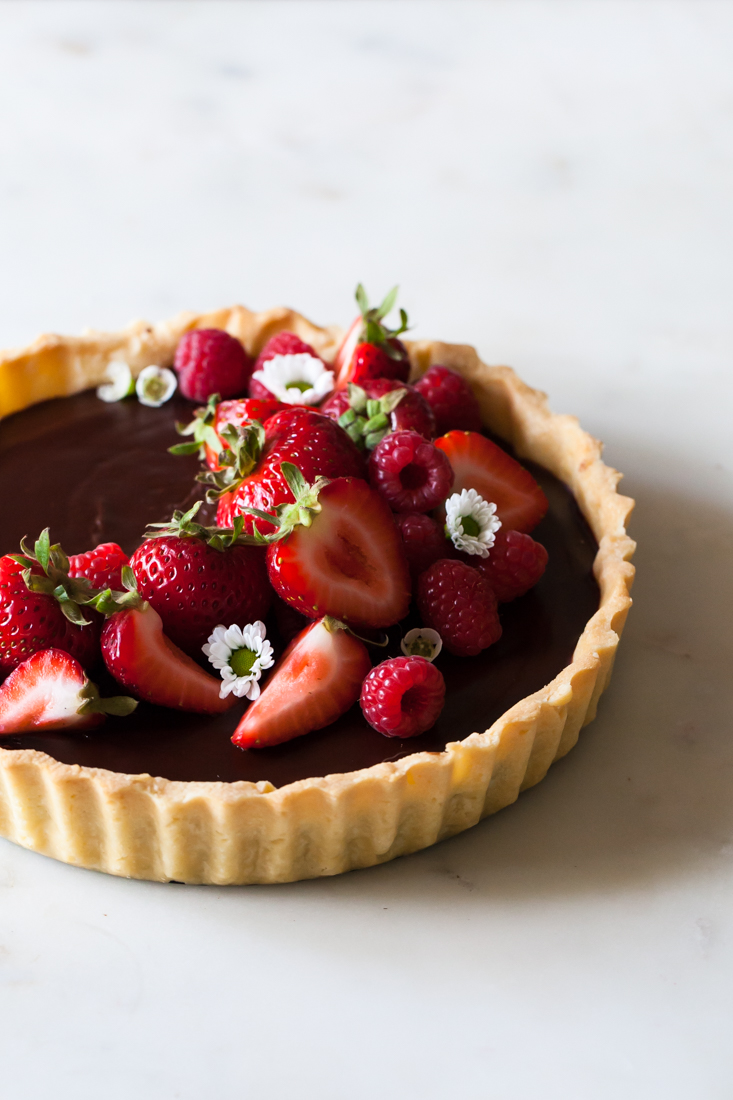 Classic Chocolate Tart with buttery crust, raspberries, and strawberries