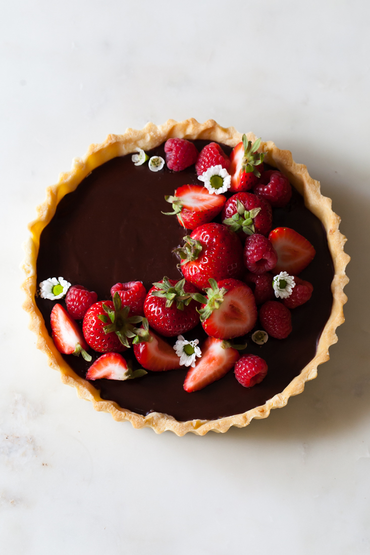 Classic Chocolate Tart with buttery crust, raspberries, and strawberries