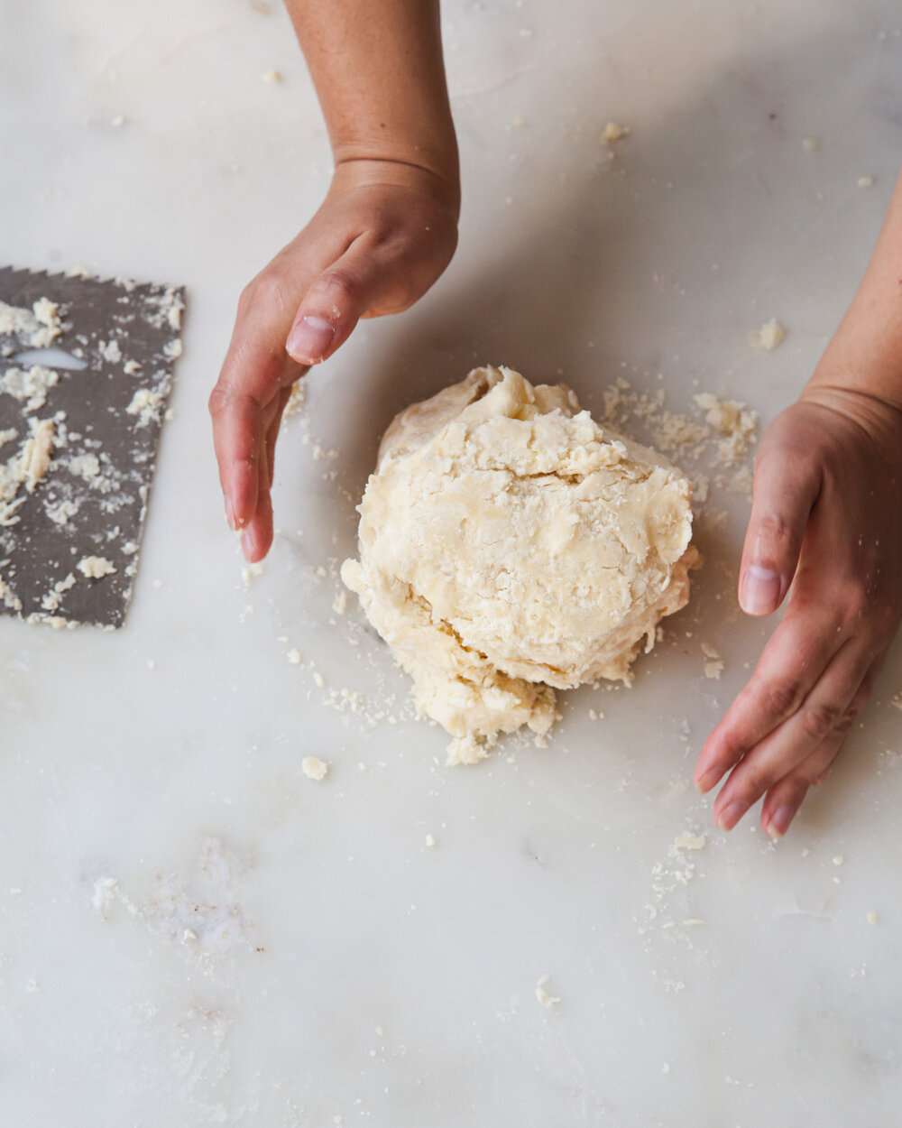 Once there are no longer stray bits of dough and before the butter becomes soft, gently gather the dough into a ball.