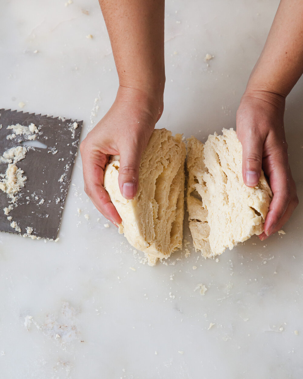 Portion the dough in half with the bench scraper. Look at all those layers!