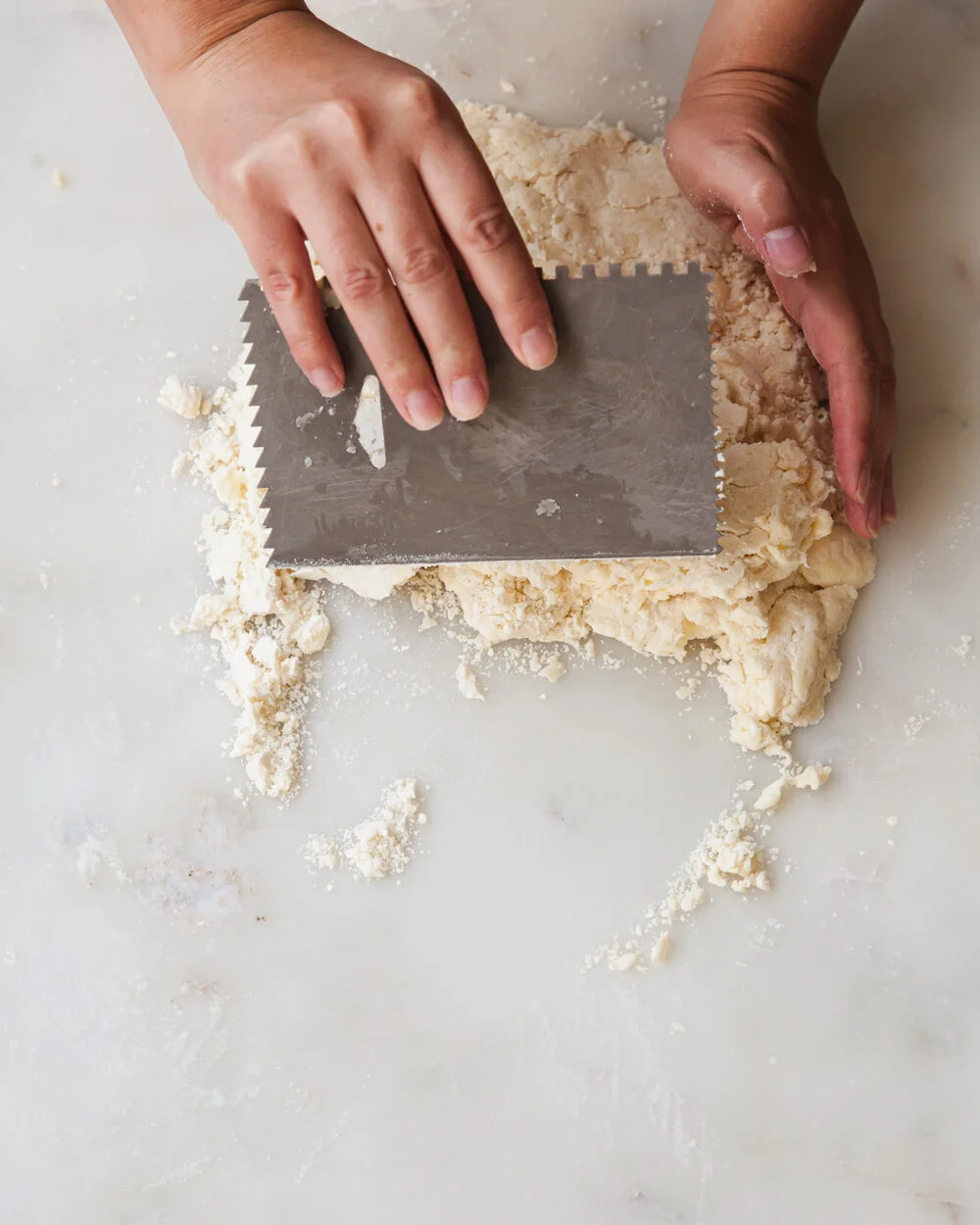 Use a bench scraper to fold the bottom third of the dough up and over to the middle.