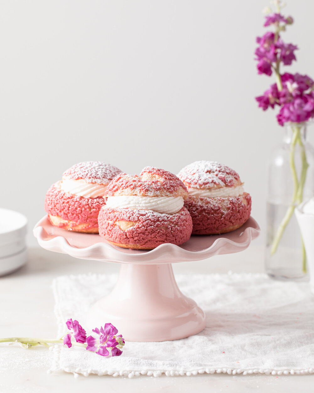 Raspberry Rose Choux Bun Recipe on a cake stand