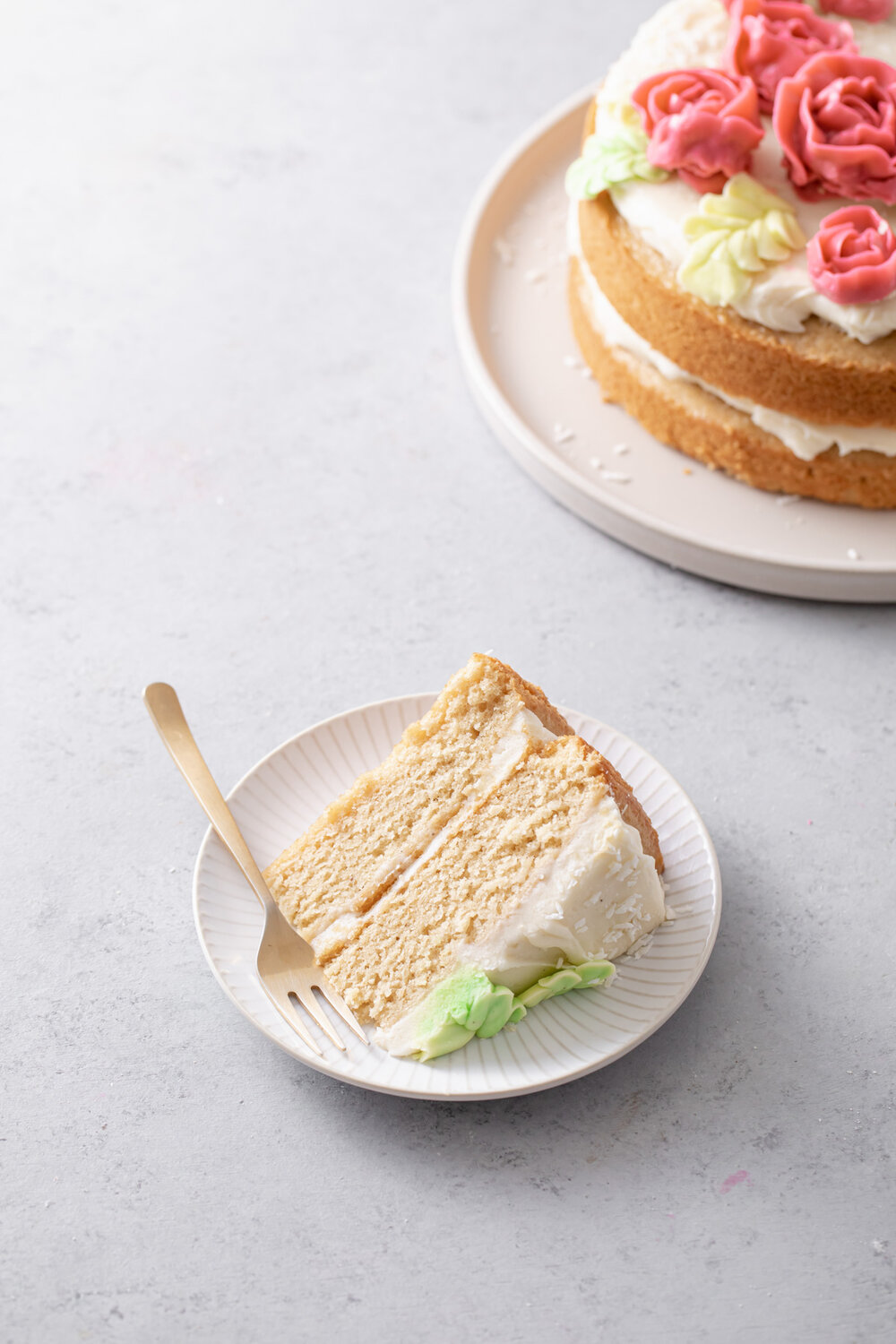 Almond layer cake with swirls of cream cheese frosting.  The perfect two-layer "naked" cake for spring!